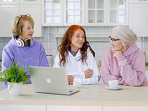 Haus beleihen für die Erbenauszahlung Drei Frauen sitzen in der Küche am Computer